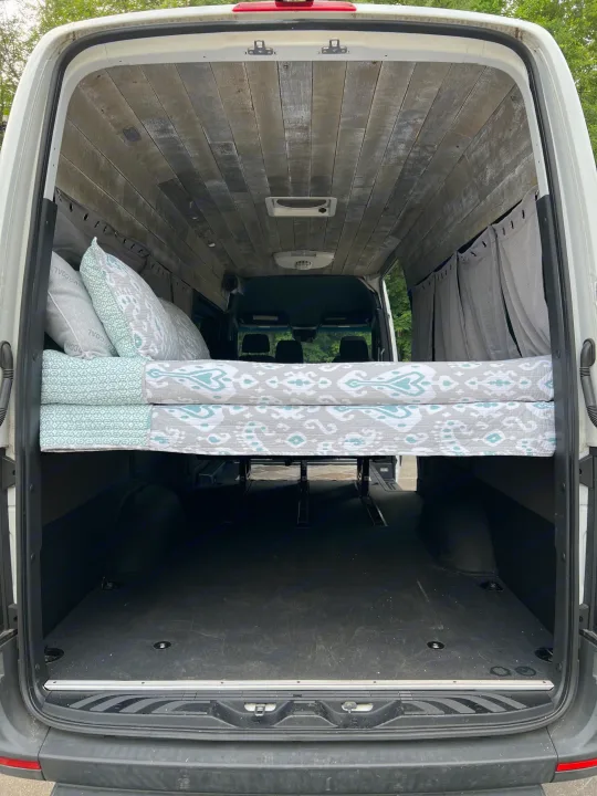 Spacious camper van conversion for your next rv rental adventure. Features elevated bed, wood ceiling, and ample storage.. Mercedes-Benz sprinter 2019