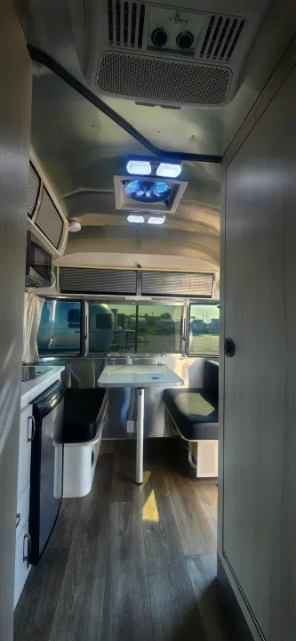 Modern Airstream RV rental interior with kitchen, dining, and stylish design. Perfect for travel adventures.. Airstream Sport 2018