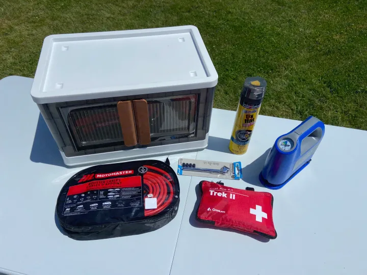 An RV rental essential: emergency kit with booster cables, tire inflator, fix-a-flat, first aid, and storage bin.. Dodge Grand Caravan 2008