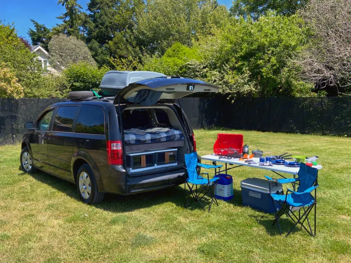 Experience adventure with this minivan RV rental. Features a comfy bed, outdoor kitchen, and camping gear for your trips.. Dodge Grand Caravan 2008