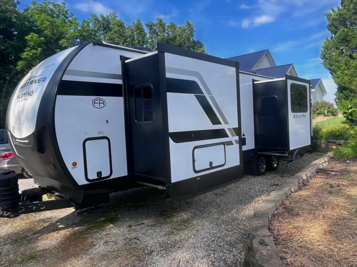 Spacious Forest River Palomino Solaire travel trailer with slide-outs extended, ready for your next rv rental adventure.. Forest river 306RKTS Palomino 2025