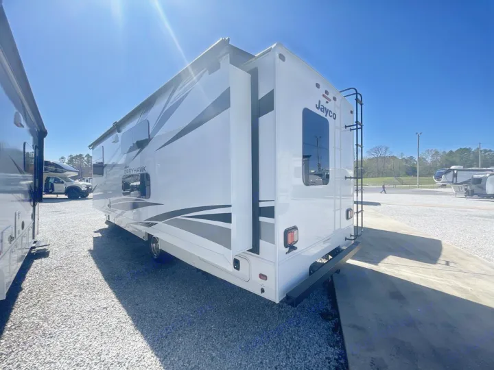 A white Jayco Greyhawk motorhome with extended slide-out and rear ladder, ready for RV rental.. Jayco Greyhawk 2026