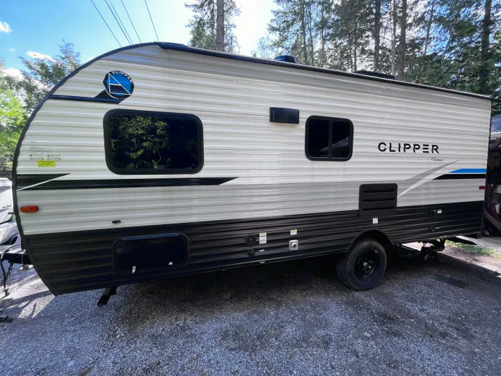 Side view of a grey and black Clipper travel trailer, an ideal camper for your next rv rental adventure.. Clipper 4K 2023