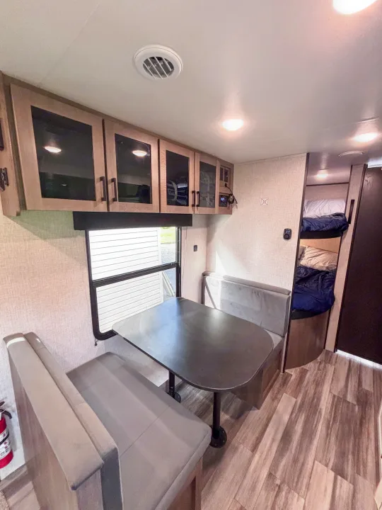 Spacious and modern RV rental interior with dinette, overhead cabinets, and cozy bunk beds, perfect for family travel.. Jayco Jay Flight slx 260 bhw 2025