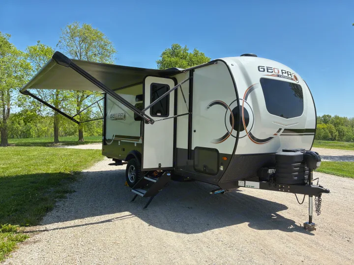 Discover this Geo Pro travel trailer RV rental, a compact camper ready for your outdoor adventures, parked on a sunny gravel path.. Forest River Rockwood Geo Pro 2024