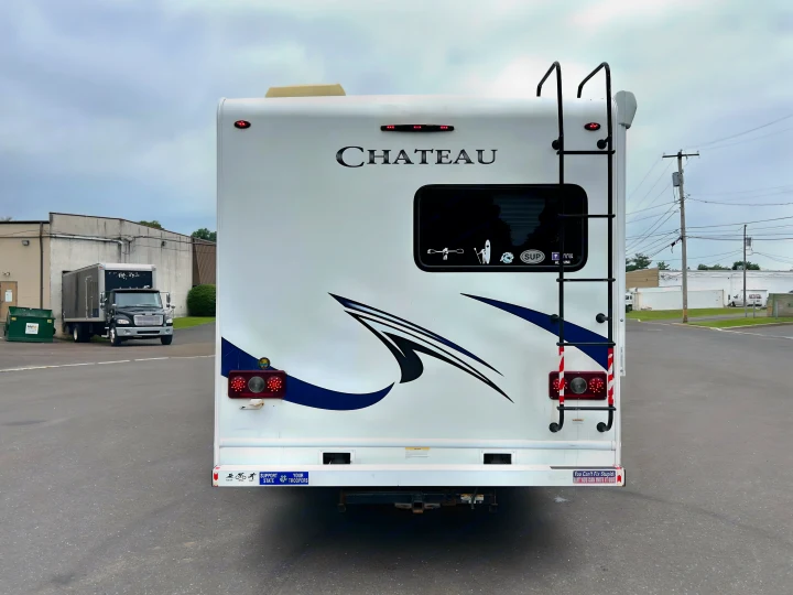 This white Chateau RV rental, seen from the rear, features a ladder and bright taillights, ready for your next adventure.. Thor Chateau 2019