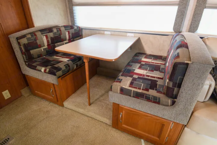 RV rental dinette with patterned cushions, a light table, and cozy seating for your travel adventures.. Monaco Safari 2009