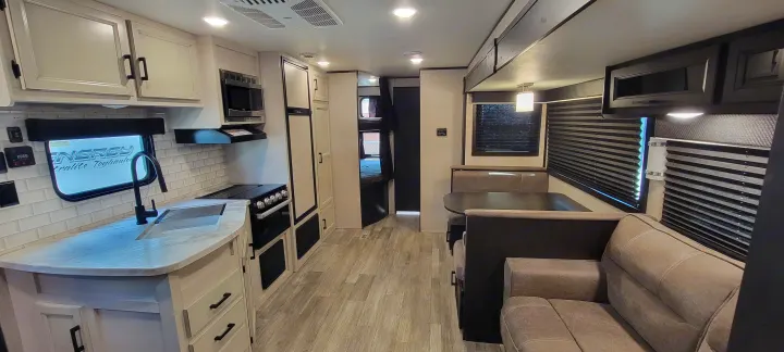 Explore this modern RV rental interior! Features a full kitchen, dinette, comfy sofa, and bunk beds, perfect for travel.. Jayco Jayco Rocky Mountain 2022