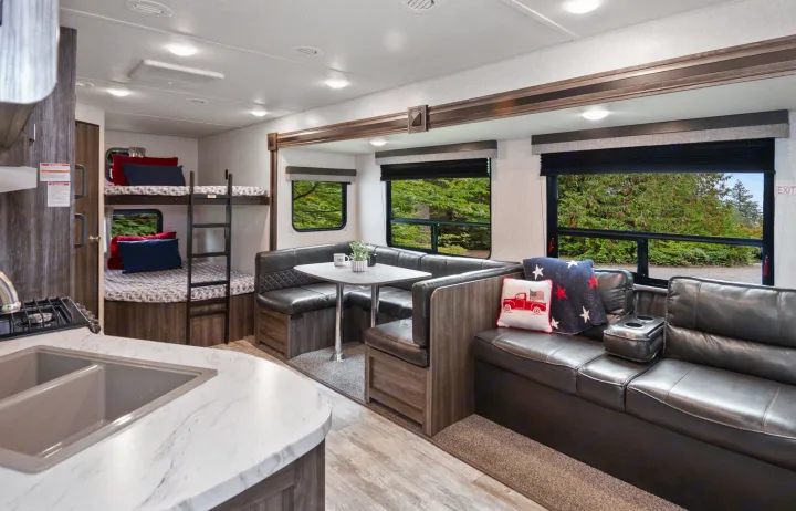 Experience comfort in this RV rental! Features include bunk beds, a U-shaped dinette, and a plush sofa. Perfect for your next adventure.. Highland Ridge RV Open Range 2019
