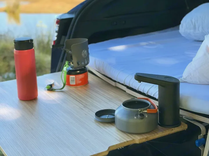 Rv rental: mobile camping setup with stove, kettle, water dispenser, and a comfy van bed.. Telstar Model Y 2023