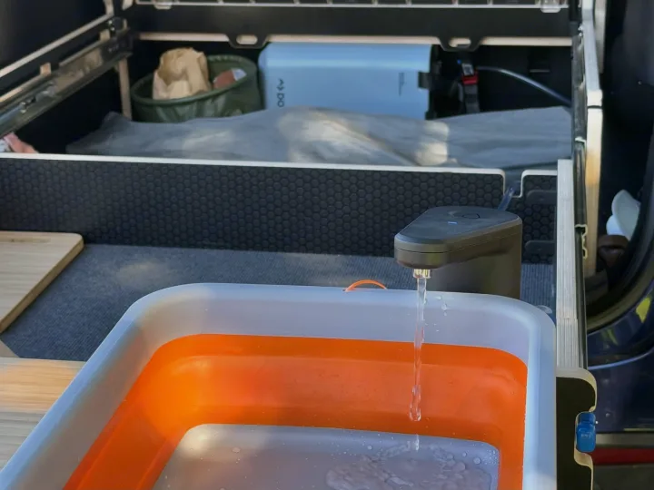 RV rental convenience: A portable Dometic water system with an electric faucet fills a collapsible sink, ready for adventure.. Telstar Model Y 2023