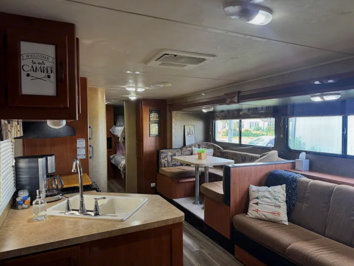 Cozy RV rental interior with kitchen, dining area, and living space. Perfect for adventures.. Forest River Cherokee Grey Wolf 2013