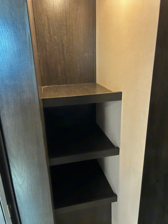RV rental: This RV features dark wood built-in shelving, providing ample interior storage for your travel essentials.. Forest River Surveyor Legend 2020