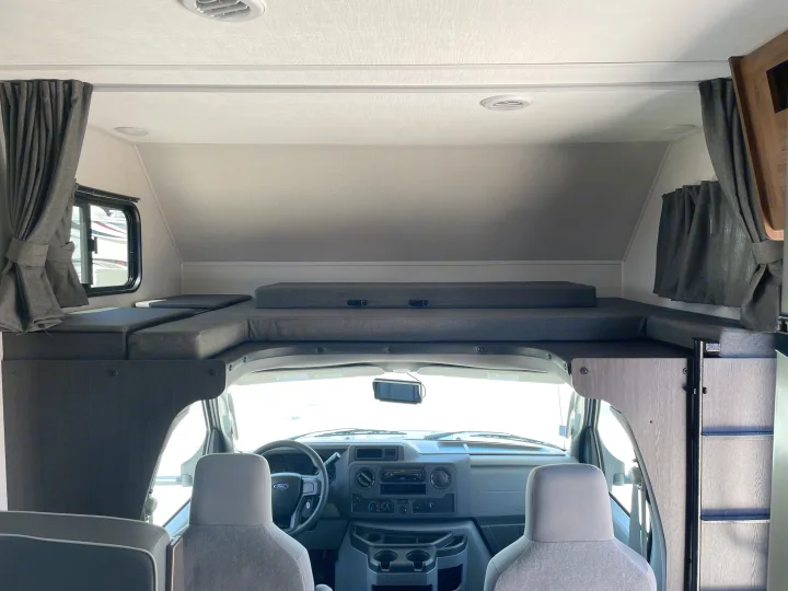 RV rental interior: View of the cab-over bunk sleeping area and driver's cockpit, ready for your next adventure.. Forest River Sunseeker 2022