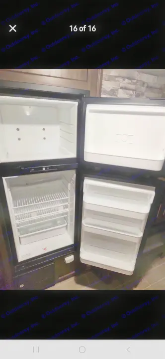 Clean compact RV rental refrigerator and freezer, open to show interior storage. Ready for your trip!. Forest River Cherokee 2020