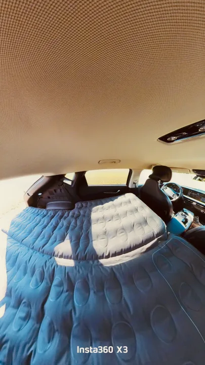 Car interior transformed into a sleeping space with an inflatable air mattress, ideal for a comfortable RV rental-like road trip. #carcamping. Kia EV6 Wind All Wheel Drive 2022