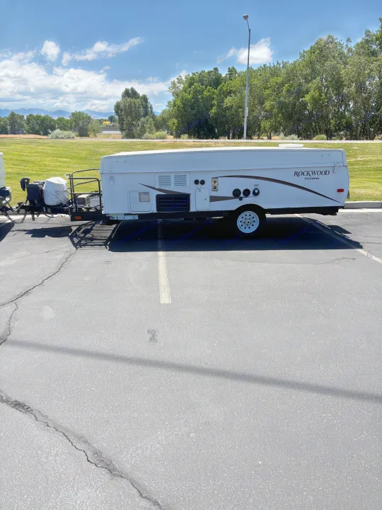 White Rockwood pop-up camper RV rental, ready for your next camping outdoor adventure.. Rockwood Freedom 2280 BH 2016