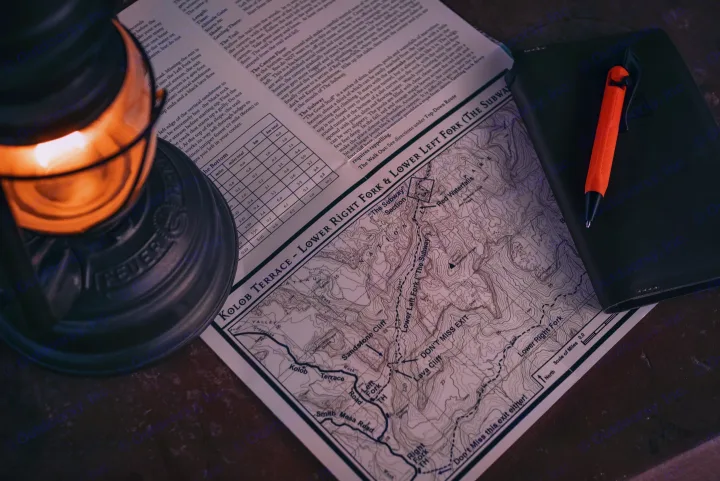 Planning an RV rental adventure: Zion's Subway canyoneering map, with a lantern and notebook for notes.. Toyota Other 2025