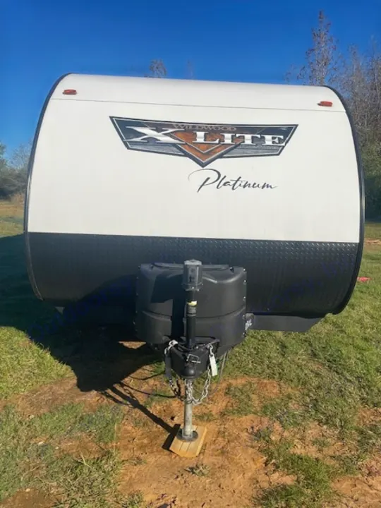 Front exterior of a Wildwood X-Lite Platinum travel trailer, ideal for your next RV rental trip.. Forest River Wildwood X-Lite 2023