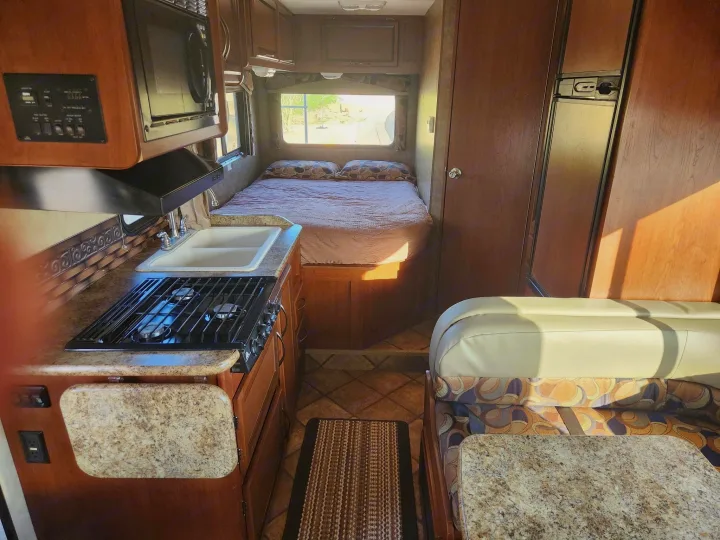 Step inside this cozy RV rental: complete kitchen, comfortable bed, and dinette, perfect for your next road trip.. Thor Chateau 2013