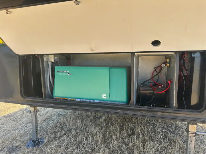 This RV rental's open compartment reveals its Cummins Onan generator and battery system for onboard power.. Jayco Seismic Toy Hauler 2017