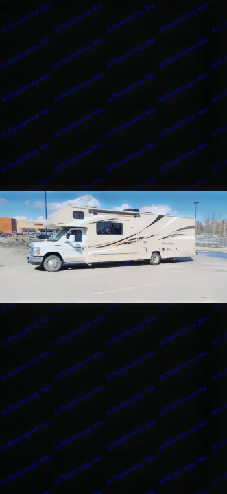 A beige Class C RV rental, a Winnebago Minnie Winnie, parked on asphalt under a blue sky.. Winnebago Minnie Winnie 2017