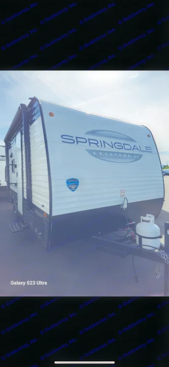 New Springdale Keystone RV travel trailer, white with black trim, and propane tank. A great option for your next rv rental.. Keystone RV Springdale 2025