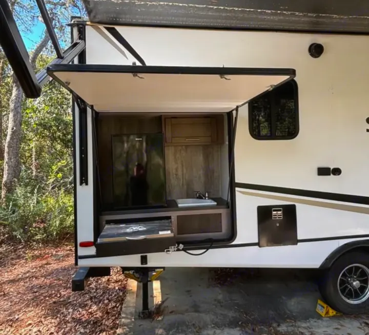 Perfect for your next adventure, this **rv rental** travel trailer features a convenient outdoor kitchen with a fridge, sink, and cooktop.. Crossroads RV Sunset Trail Super Lite 2022