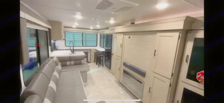 Modern RV rental interior with a spacious living area, kitchen, and dining setup. Ideal for travel comfort.. Forest River Salem View 2024