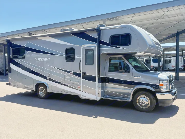 A sleek gray and black Forest River Sunseeker Class C RV, an excellent option for rv rental, parked under cover.. Forest River Sunseeker Classic 2021