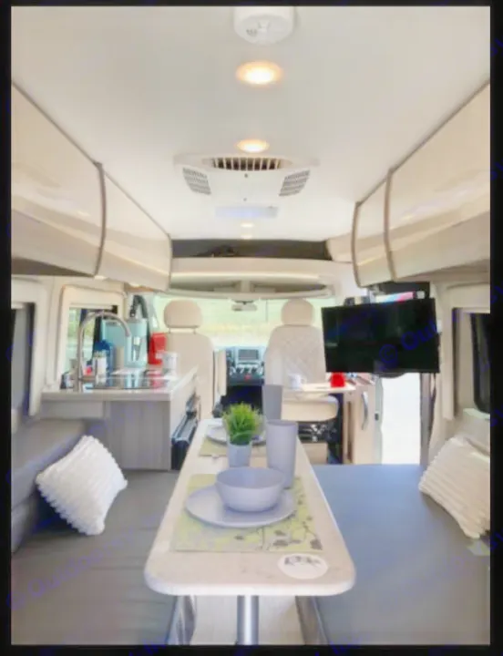 Explore this modern RV rental interior! Features dining, kitchenette, and cozy seating, ideal for your next camper van road trip.. Jayco Swift 2021