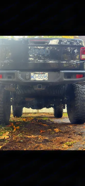Rear of a black Jeep Gladiator pickup with large tires and BC plate WD-5596. Ready for an RV rental adventure.. Dodge Jeep Unlimited X 4x4 2021