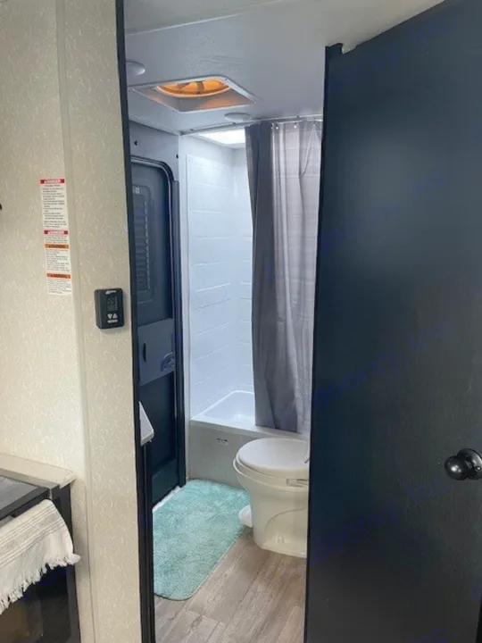 Step inside this cozy RV rental's bathroom! Features a shower, toilet, and compact design for your adventures.. Forest River Cherokee 2022