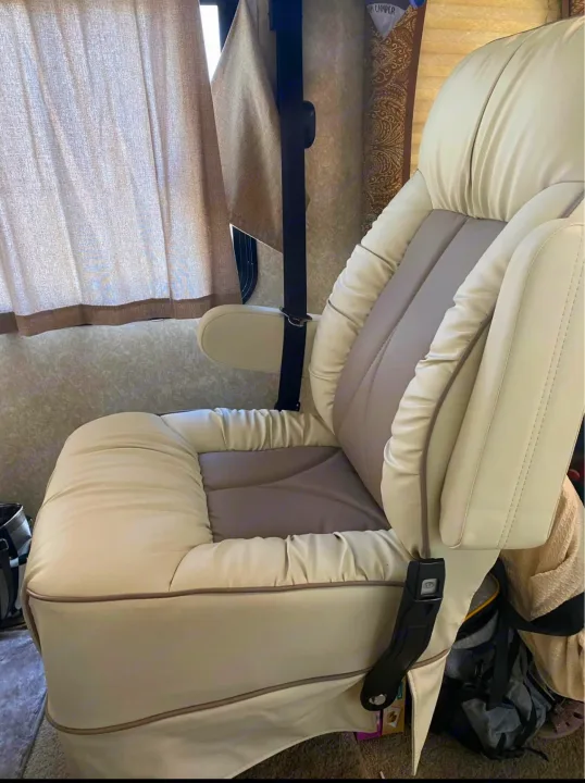 Experience comfort in this stylish cream & grey captain's chair within an RV rental. Ideal for relaxing on your journey.. Hurricane F53 2010