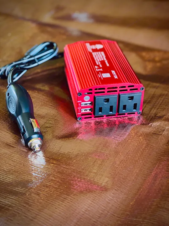 Red BESTEK 300W power inverter with 12V car plug, two AC outlets, and dual 2.4A USB ports. Ideal for RV rental.. Ford Transit Custom 2015