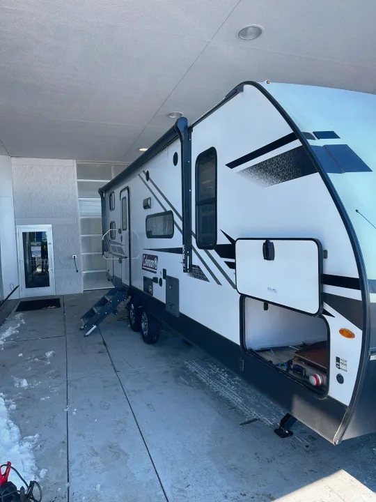 Explore with this clean Coleman RV rental, parked under an overhang with steps down, ready for your next camping trip.. Coleman Dutchman Light 2023