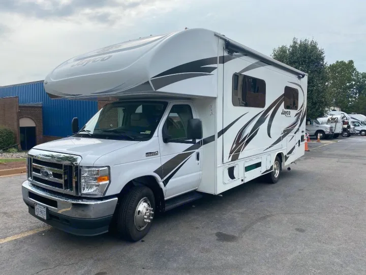 This clean, white Class C motorhome with "Jayco" branding is ready for an unforgettable RV rental experience.. Jayco Redhawk 2021