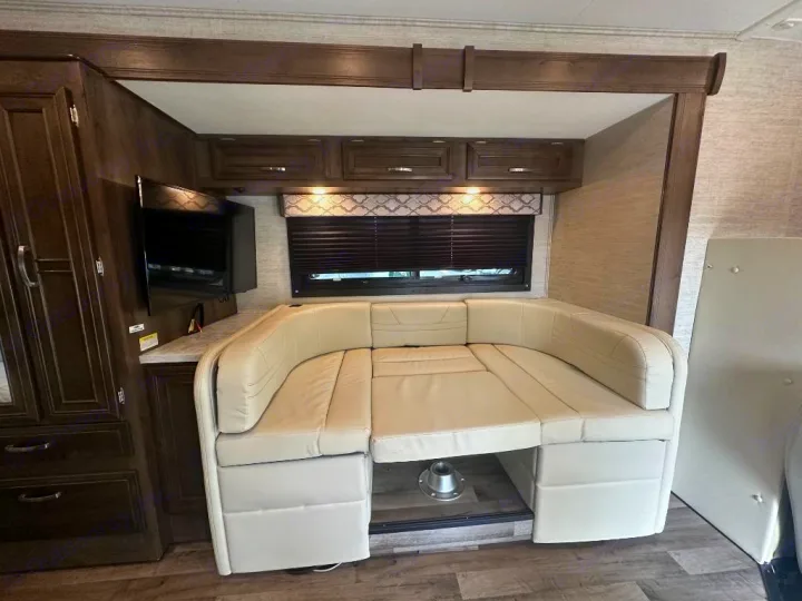 Explore this RV rental's versatile interior! Features a U-shaped dinette converting to a bed, TV, and storage.. Jayco Redhawk 2021