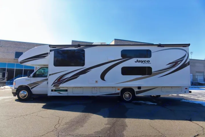 Spacious Jayco Redhawk RV rental, perfect for your next adventure. This white motorhome is parked on a sunny day.. Jayco Redhawk 2021