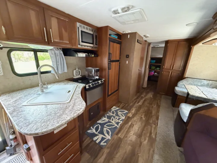 Spacious RV rental interior with a functional kitchen, dining area, and cozy living space. Ideal for your next adventure.. Forest River Tracer Air 2016