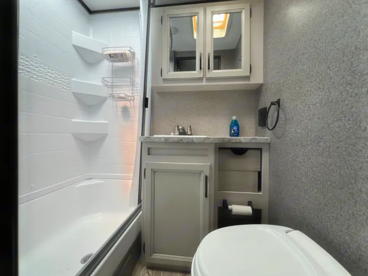 Clean, modern RV rental bathroom with a shower/tub combo, toilet, and vanity. Essential amenities for comfortable travel.. Jayco Jay Feather Micro 2021