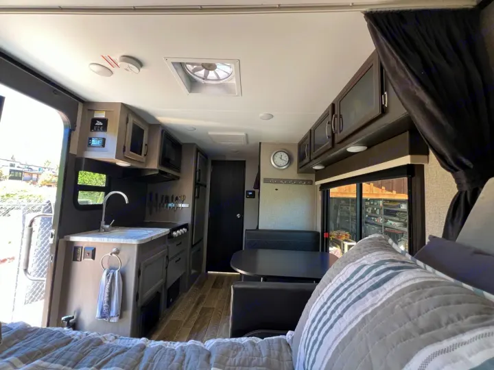 Spacious RV rental interior featuring a modern kitchen, cozy dinette, and comfortable bed area, ready for adventure.. Jayco Jay Feather Micro 2021