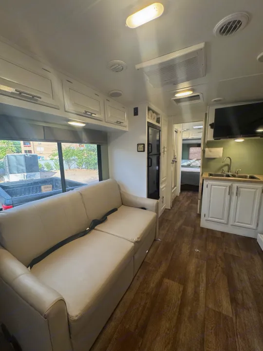 Spacious RV rental interior featuring a comfy sofa, full kitchen, and bedroom access. Ideal for road trips!. FR3 FR3 Motorhome 2016