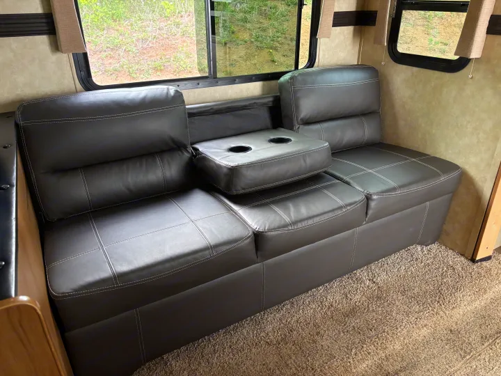 RV rental: spacious, dark gray upholstered sofa with cup holders, perfect for relaxing after adventures.. Cruiser Rv Corp 280Bunkhouse Cruiser 2015