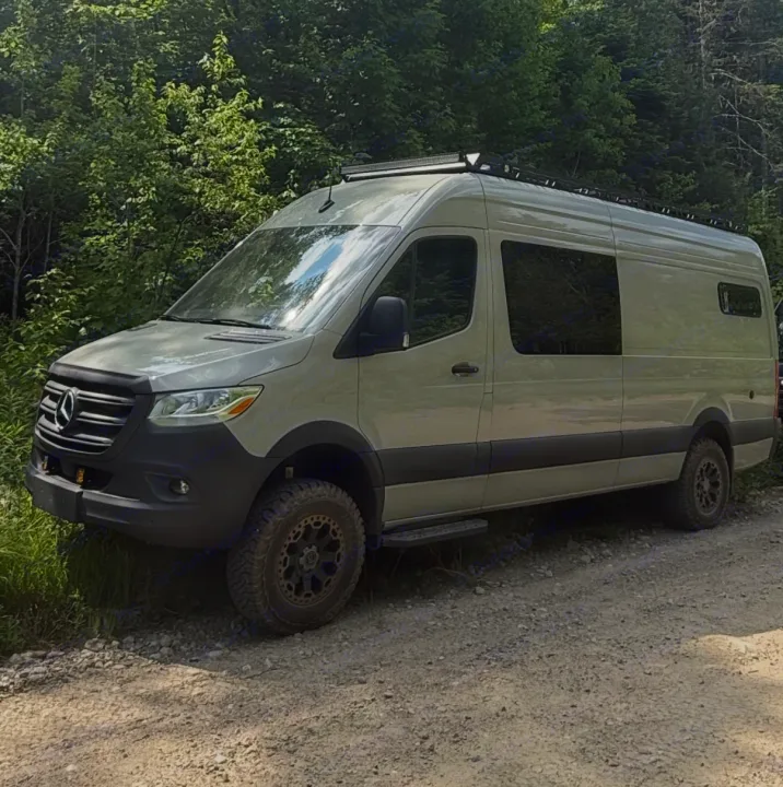 Adventure-ready Mercedes-Benz Sprinter van, modified for off-road travel, available for rv rental. Parked by a forest.. Mercedes-Benz sprinter 2024