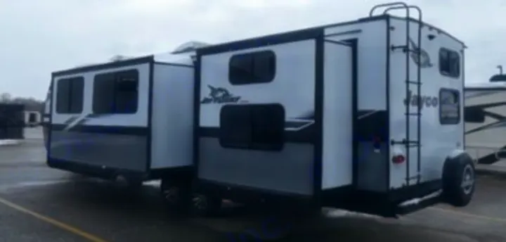 Spacious grey and white Jayco travel trailer with slide-outs extended, ideal for your next RV rental adventure.. Jayco Jay Flight SLX 2024