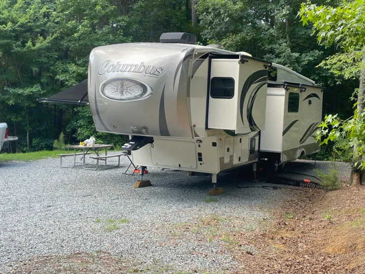 Ready for adventure! This spacious Columbus fifth-wheel RV rental is parked at a serene, tree-lined campsite.. 4x4fcmp23h6007284 Columbus 2017