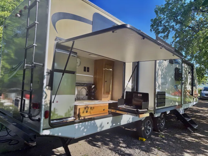 Spacious RV rental with an amazing outdoor kitchen featuring a fridge, sink, and pull-out grill. Perfect for camping!. Coachmen Freedom Express Ultra Lite Maple Leaf Edition 2019