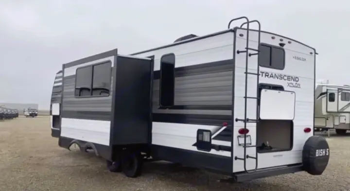 Explore this white and grey Transcend Xplor travel trailer, featuring a slide-out, available for rv rental.. xpolar 265bh 2023