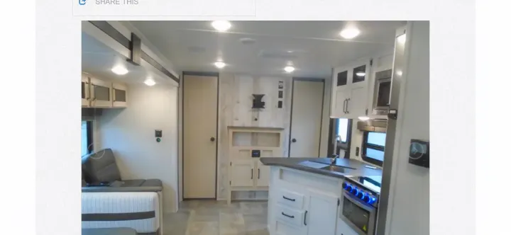 RV rental interior featuring a modern kitchen with a blue-lit stove, and a comfortable living area. Ideal for travel.. Palomino PUMA XLE 2023